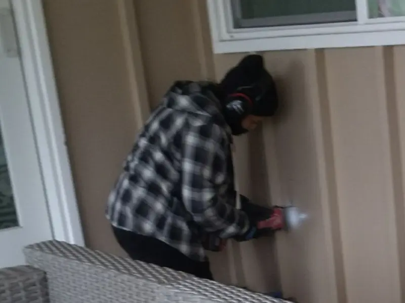 Professional electrician installing an exterior outlet in Roselawn